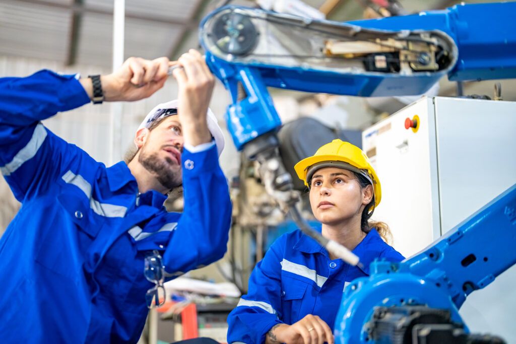 engineer with robot in automotive parts factory